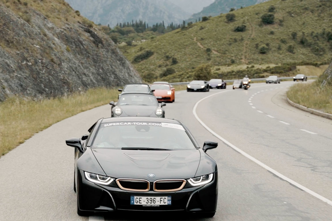 a group of supercars driving on a road - Rallye Baviere